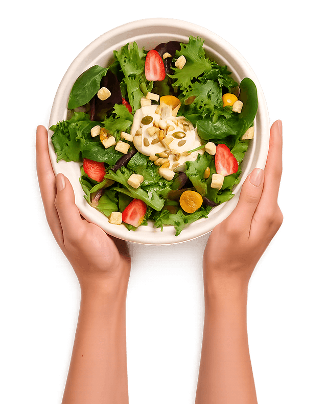 Hands holding a bowl of fresh salad